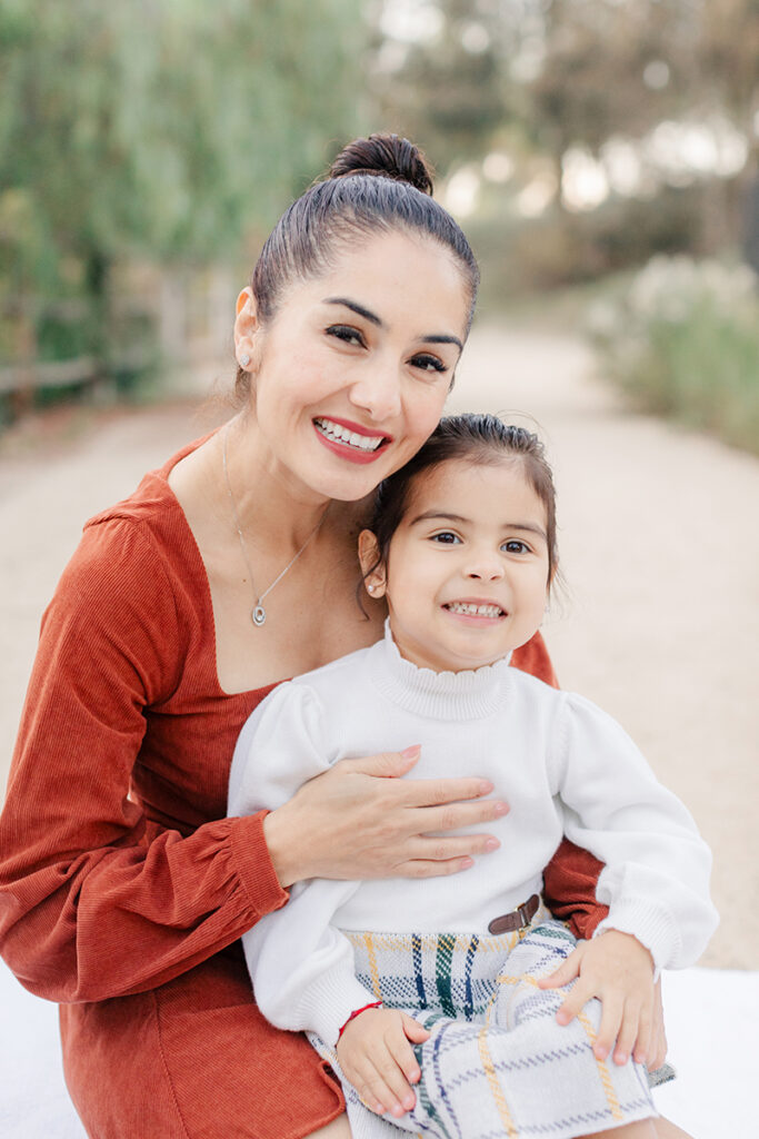 Mother and daughter smiling together during a family photoshoot at Montevalle Park in Chula Vista, captured in soft natural light
